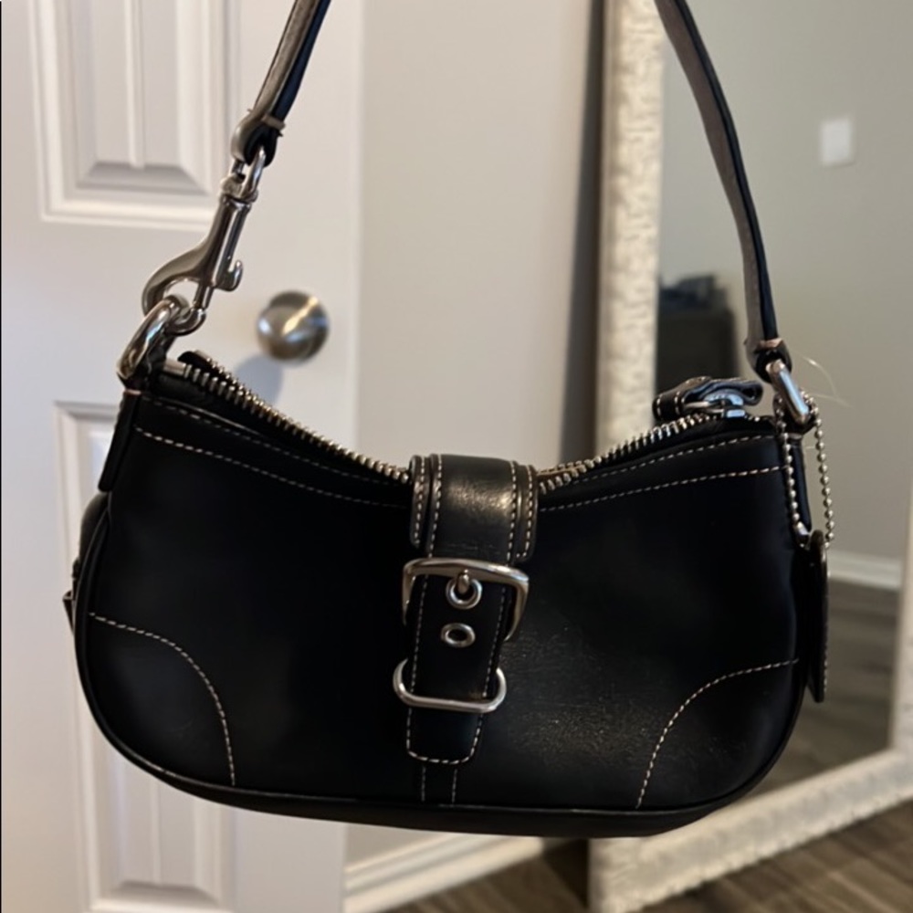 Small black leather coach purse with silver zipper and buckle